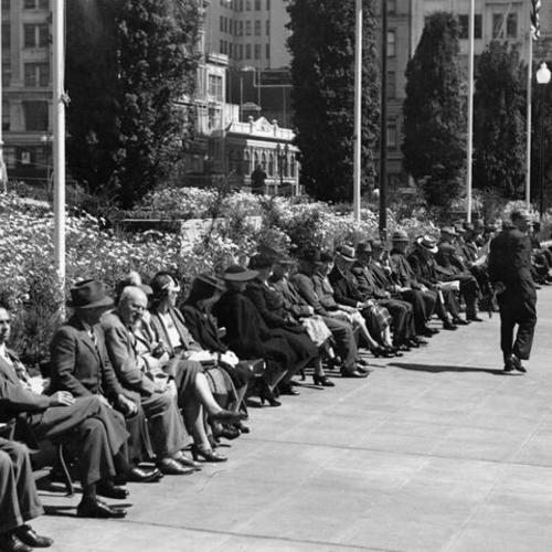[Benches lined with people in Union Square]