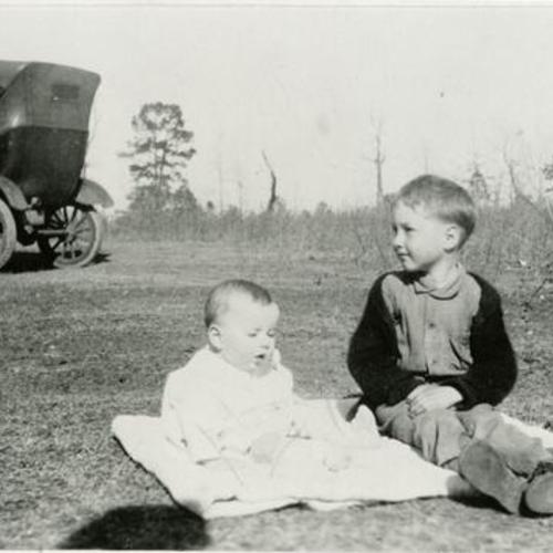[Two brothers next to grandfather's Model T Ford automobile in Texas, 1926]