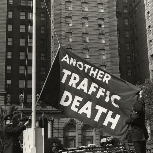 [Officers Ed Connell and Frank Dunphy raise the "another traffic death" flag in Union Square]