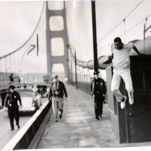 [Billy Crosby jumping down from a supporting cable on the Golden Gate Bridge after he was dissuaded from committing suicide]