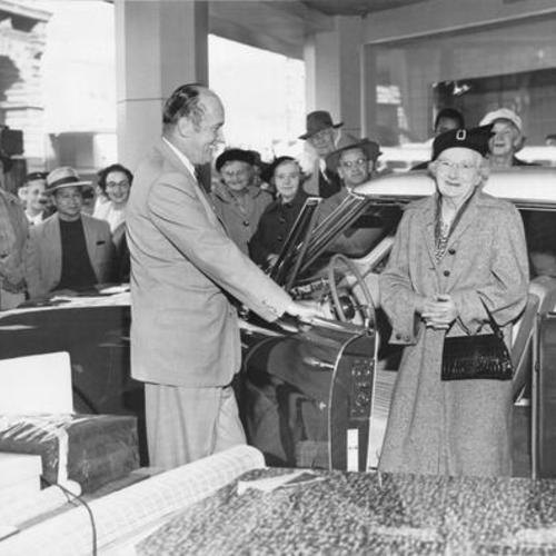 [Mrs. Rose Van Dusen, winner of a contest sponsored by Hale Brothers store, being awarded a 1953 Studebaker by William J. Ahern]