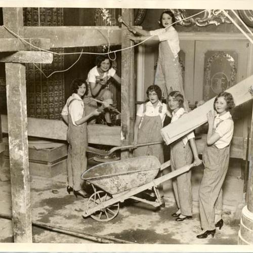 [Women posing as construction workers during the construction of the Fox theater]