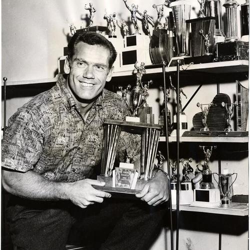 [Patrolman William Stathes with trophy for 4th place in Mr. America contest]