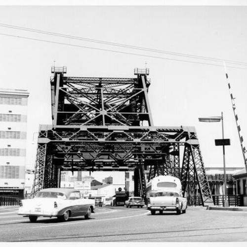 [View of autos and bus crossing Third street bridge]
