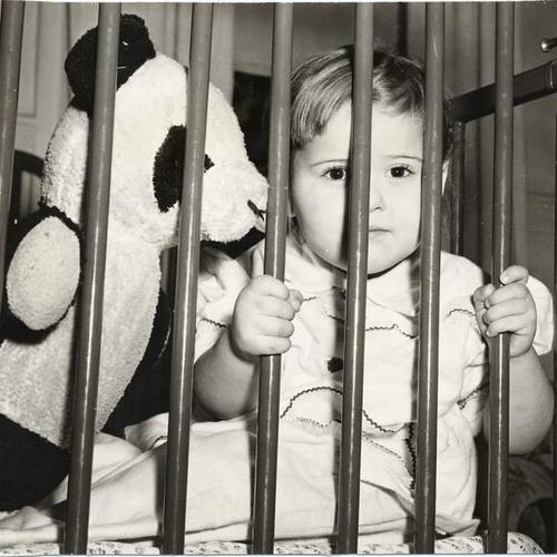 [Young child in a crib at the Laguna Honda Children's Home]