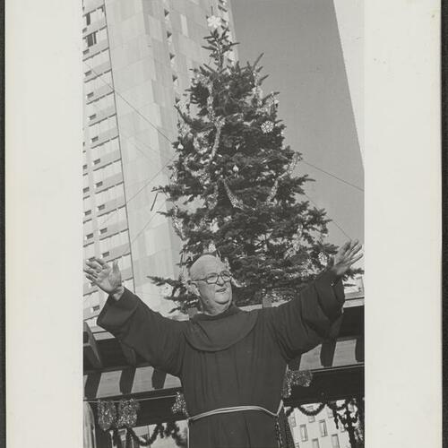 Father Alfred Boeddeker giving his blessing at tree lighting ceremony for Festival of Lights