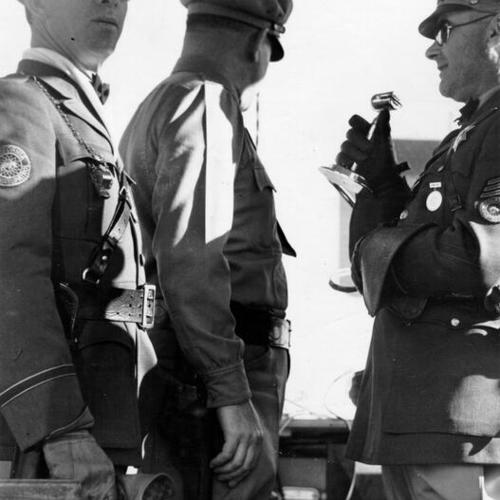 [Highway patrol private J. C. Wallace, Lieutenant Varni and Sergeant R. Hewett in Bay Bridge control station]