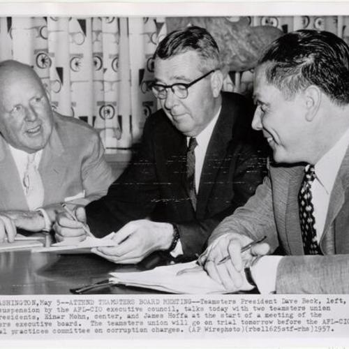 [Teamsters President Dave Beck, talking with Teamsters union vice presidents, Einar Mohn and James Hoffa]