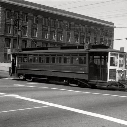 [Hayes street and Masonic avenue looking northwest at inbound #21 line car 110 passing Lowell High School]