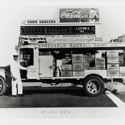 [Angelo working and standing next to the Spreckels Russell Dairy truck]