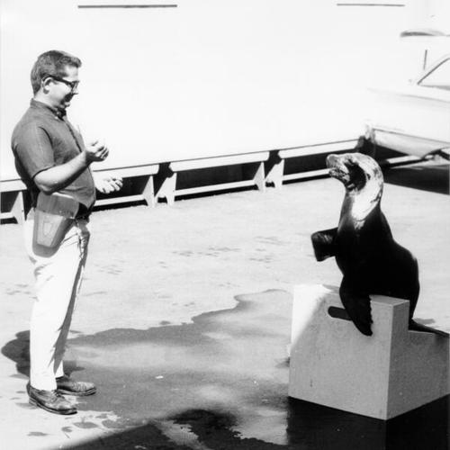 [Man with a trained seal visiting students at Treasure Island School]