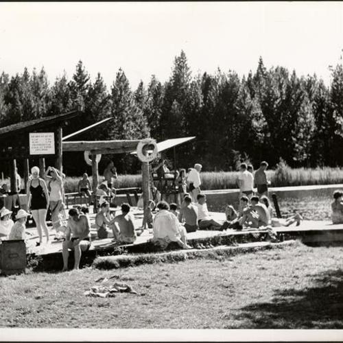 [Campers relaxing near Birch Lake at Camp Mather]