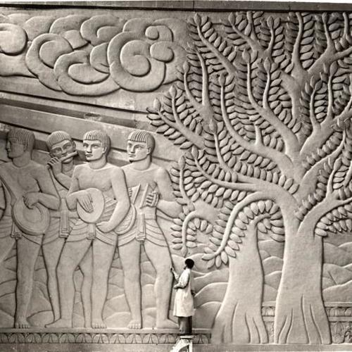 [Sculptor Jacques Schnier working on the bas relief 'Dance of Life', Golden Gate International Exposition on Treasure Island]