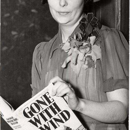 [Margaret Mitchell, author, holding her novel "Gone with the wind"]