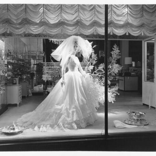 [Wedding gown window display at the City of Paris department store]