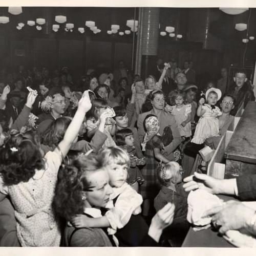 [Parents buying dolls for their daughters at the auction of unclaimed merchandise at Seventh and Mission Post Office]