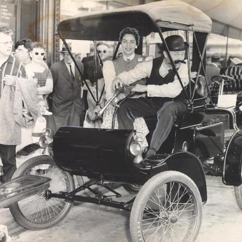 [J. C. Penney employees Carmine Villar and Bob Bauer during a "horseless carriage parade" marking the stores 56th anniversary]