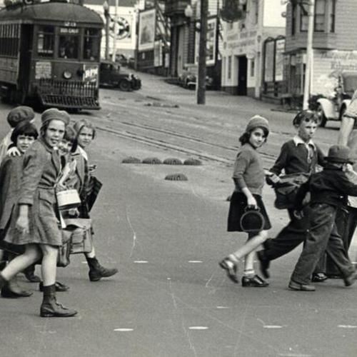 [Children being safely escorted across busy Geary and Cook street]