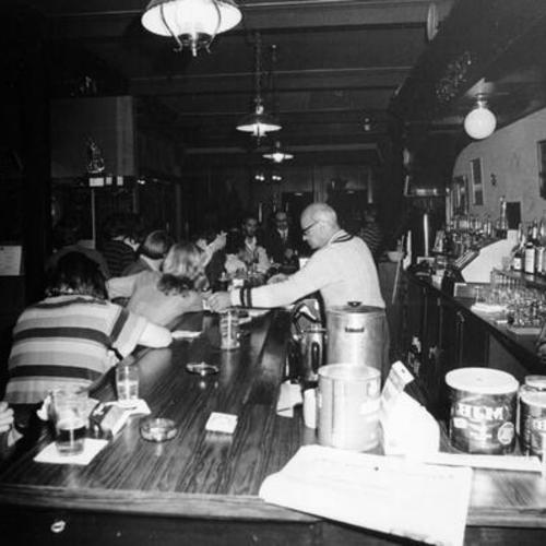 [Bartender attending customers at the Little Shamrock bar located at Lincoln and 10 th Avenue]