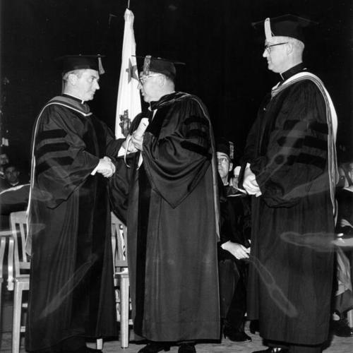 [Father Connolly (left) confers law degree upon Governor Edmund G. Brown]