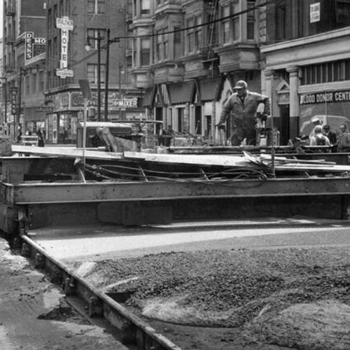 [Workers operating a concrete spreader on Mission Street between 4th and 5th streets]