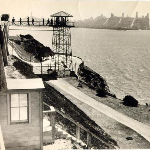 [Group of people on walkway to guard tower at Alcatraz Island Federal Penitentiary]