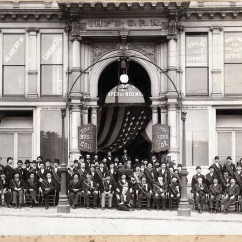 [Members of Pacific Business College posing in front of building]