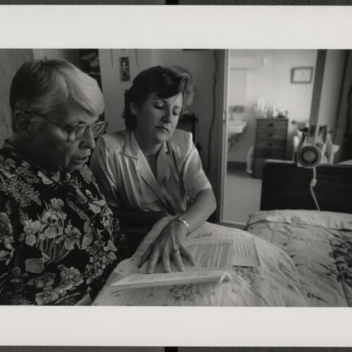 Project Read volunteer Ann Telhorst (Right) tutoring Dorothy Conley in reading