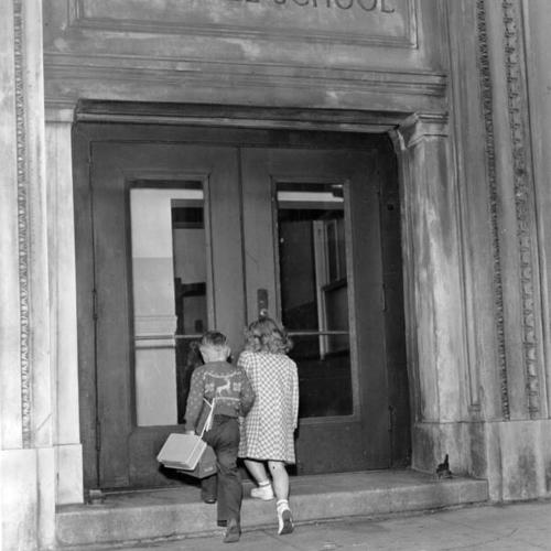 [Edward Sherwood, 5, and Donna Kay Sutton, 6, entering Marshall Elementary School]