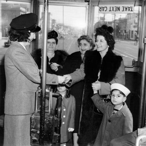 [Reporter Lois Thomas collecting transfers on a streetcar at 10th Avenue and Geary Boulevard]