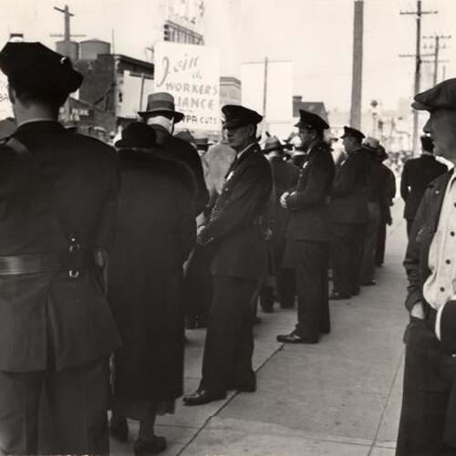 line of police holding pickets away during the 1937 WPA strike]