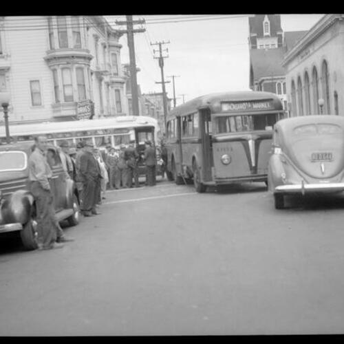 [Crowd looks on at collision of Muni bus and Greyhound bus, looking east on 23rd and Mission Streets]