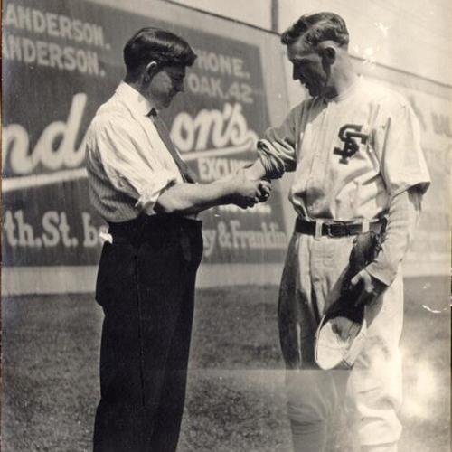 [San Francisco Seals trainer Danny "Doc" Carroll and player Charles Baum at Oakland]