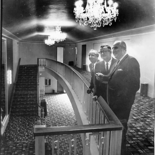 [John Tartaglia, Charles Minehart and John Klee stand under magnificent chandeliers of new Parkside Theater]