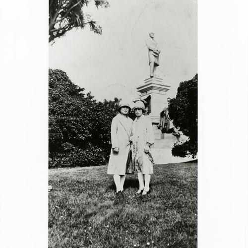 [Two friends standing next to a monument in Golden Gate Park]