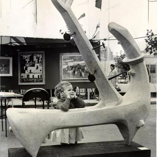 [Kathy Dickinson leaning on an art display by sculptor Elio Benvenuto]