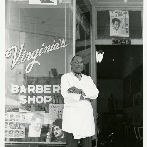 [Barber standing outside Virginia's Barber Shop on Fillmore Street near Sutter]
