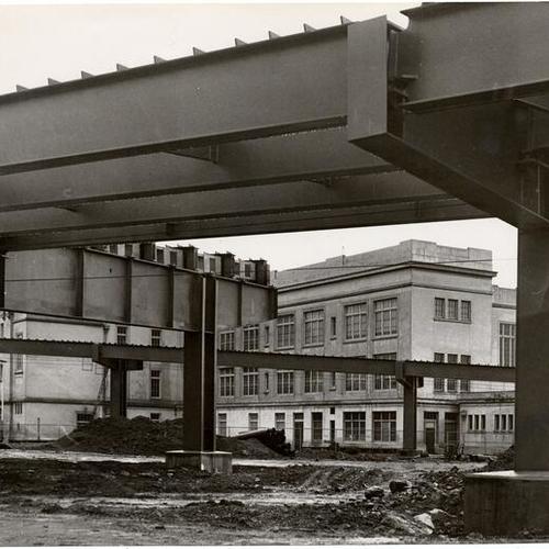 [Franklin School with girders of highway under construction in foreground]