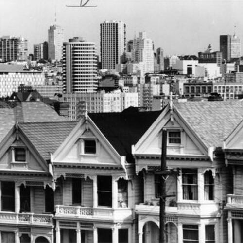 [View of Victorian houses on Steiner Street with downtown San Francisco in background]