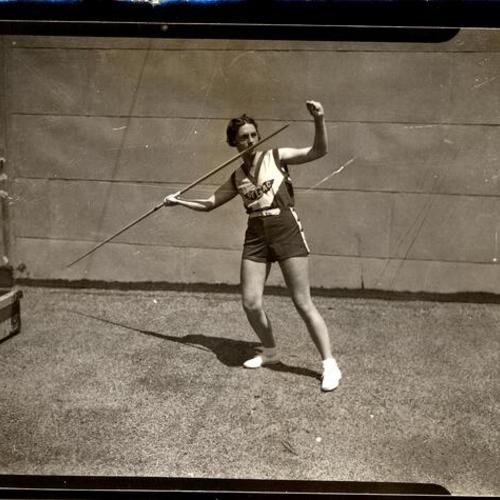 [Young woman practicing javelin throw]