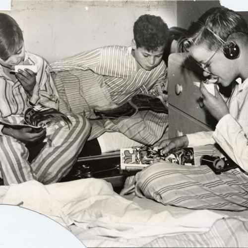 [Three boys having a bedtime snack at Edgewood Orphanage]