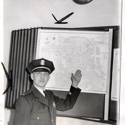 [Lieutenant Thomas P. McInerney of the Police Traffic Bureau pointing to map localizing San Francisco traffic danger points]