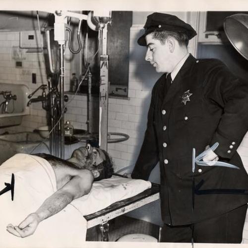 [Officer Thomas Smith observing Lewon Melkonian as he lies down in a stretcher]