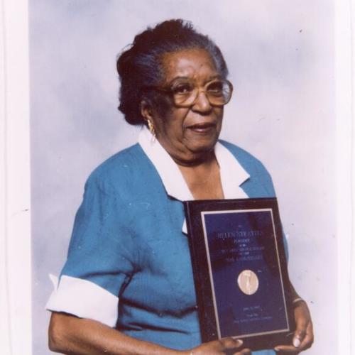 [Helen holding a Bay Area Service League plaque recognizing her for 50 years of service]