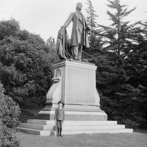[Unidentified boy posing in front of monument to Thomas Starr King in Golden Gate Park]