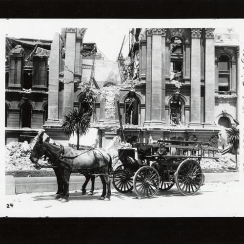 [Horse drawn fire engine in front of a  building destroyed by the 1906 earthquake]