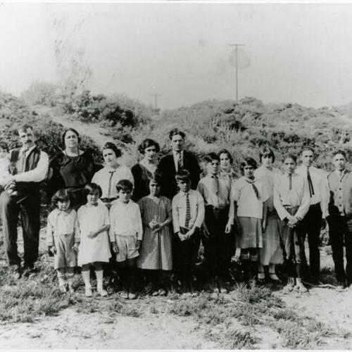 [Portrait of Bridget's father as a child with his fifteen siblings and parents standing by Lawton Street and 22nd Avenue]
