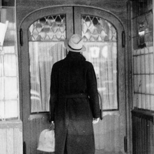 [Unidentified man standing at the entrance to the Rainbow Tavern]