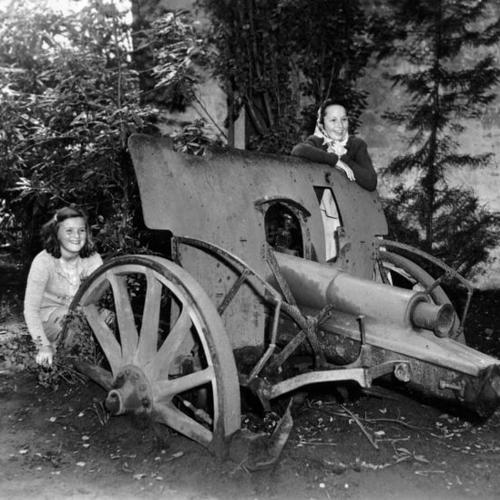 [Aleda Mialocq (left) and Diane Garfinkel (right), stand near a cannon in Golden Gate Park]