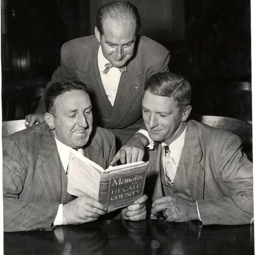 [(L to R) Lieutenant John Meehan, Prosecutor Vincent Mullins, and Inspector Fred W. Keyworth reading "Hecate County" book]